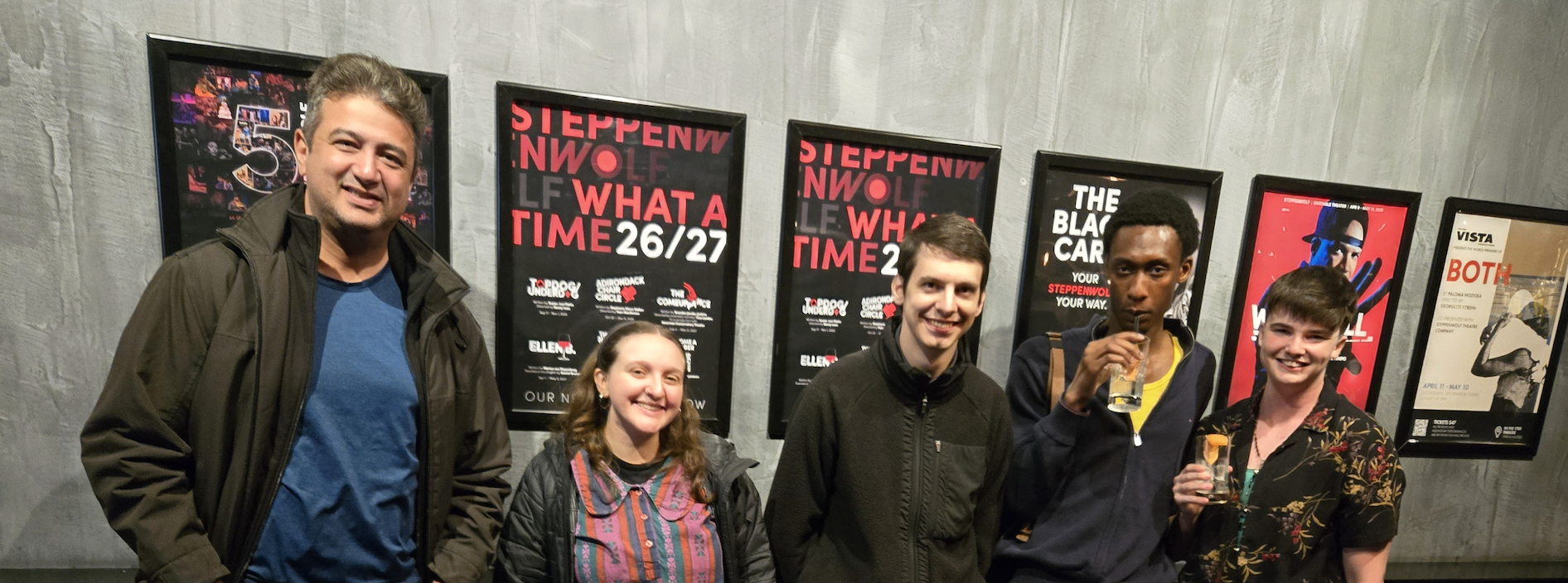 Community Members that went to a play at the Steppenwolf Theater standing in a row and smiling at the camera